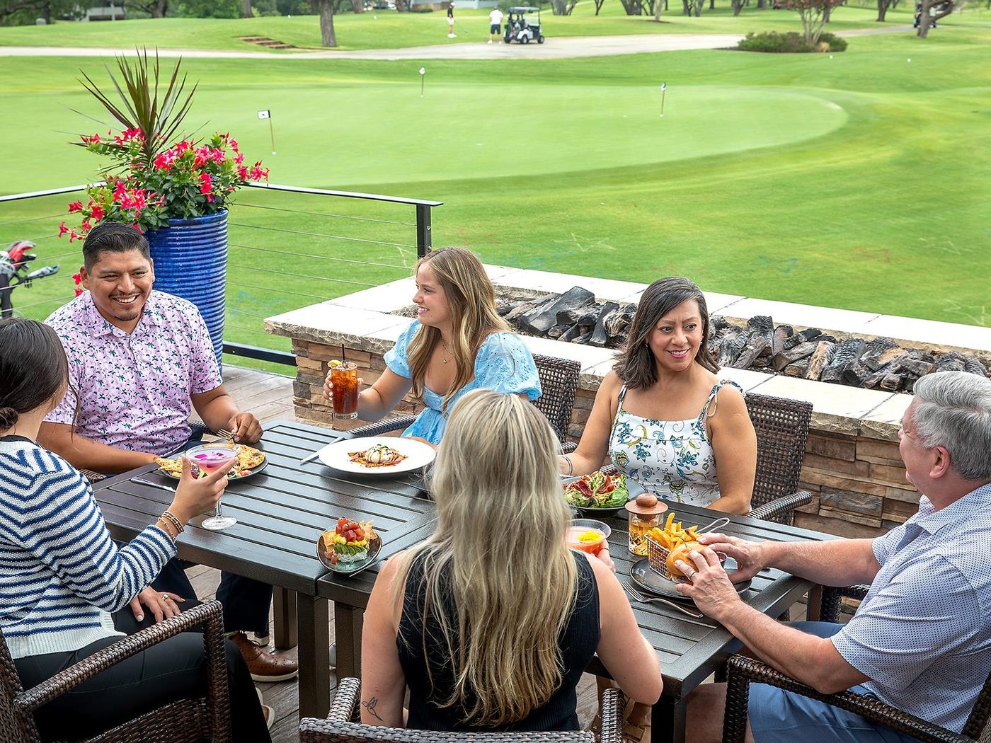 Friends at lunch on a terrace above the course